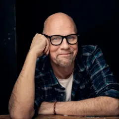 Tomas Tivemark, en skallig man med glasögon och rutig skjorta, lutar sig mot sin hand.
