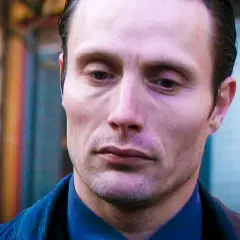 Mads Mikkelsen som Hannibal Lecter i rollistan i Mordkommissionen. Hans blick är intensiv och tankfull.