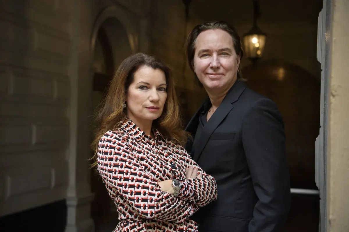 Alexandra Coelho Ahndoril och en man står tillsammans framför en byggnad.